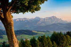 Scenic view of Appenzell's picturesque landscape with mountains and lush greenery at twilight.